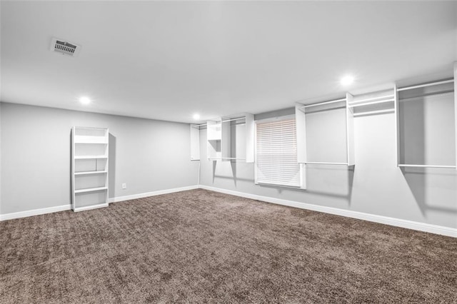 walk in closet featuring carpet flooring