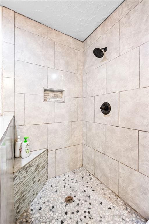 bathroom with a tile shower