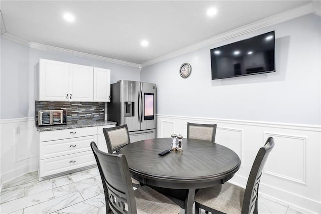 dining room featuring ornamental molding