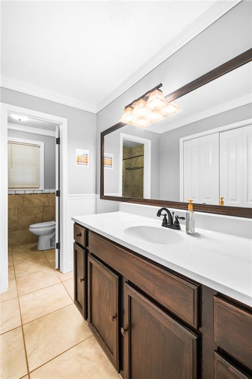 bathroom featuring toilet, tile patterned flooring, vanity, and ornamental molding