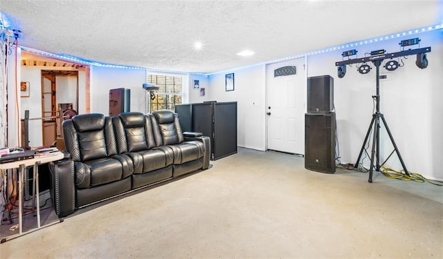 home theater with concrete floors and a textured ceiling