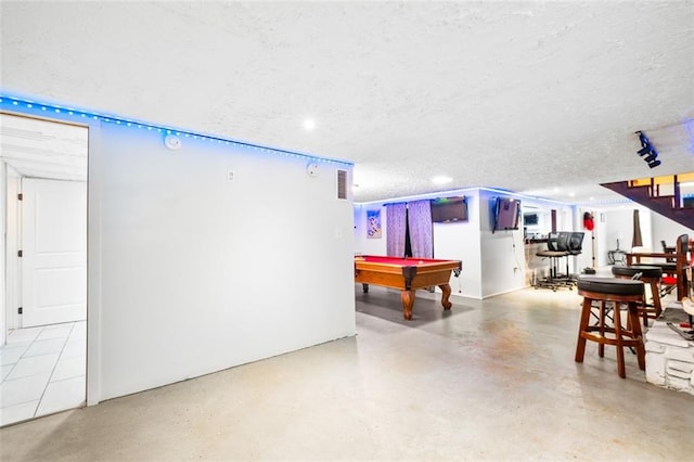 rec room with a textured ceiling and pool table