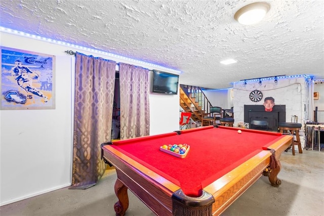 playroom featuring concrete flooring, a textured ceiling, and billiards