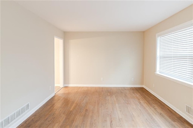 unfurnished room with light hardwood / wood-style flooring