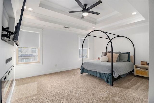 bedroom featuring crown molding, carpet floors, a raised ceiling, and ceiling fan