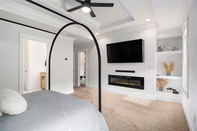 bedroom with ensuite bathroom, light colored carpet, ceiling fan, a raised ceiling, and crown molding