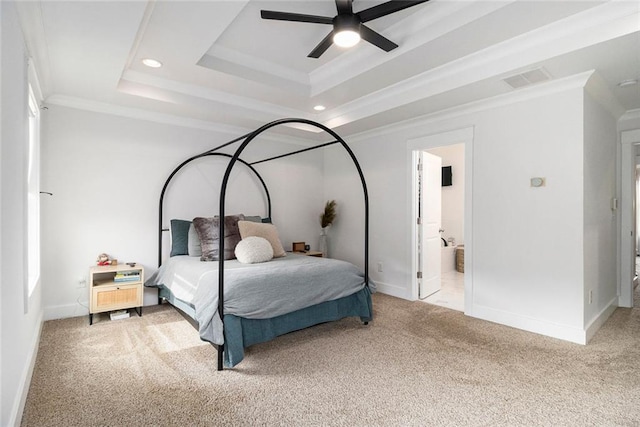 bedroom featuring crown molding, light colored carpet, a tray ceiling, and ceiling fan