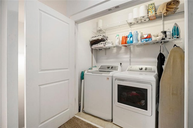 clothes washing area featuring independent washer and dryer