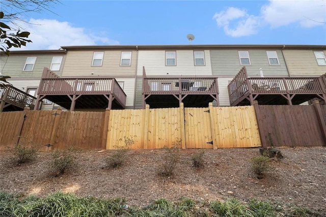 back of house with a wooden deck