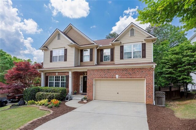 property entrance featuring brick siding, a garage, and driveway