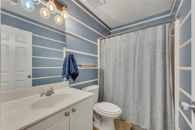 full bathroom featuring vanity, toilet, curtained shower, and tile patterned floors
