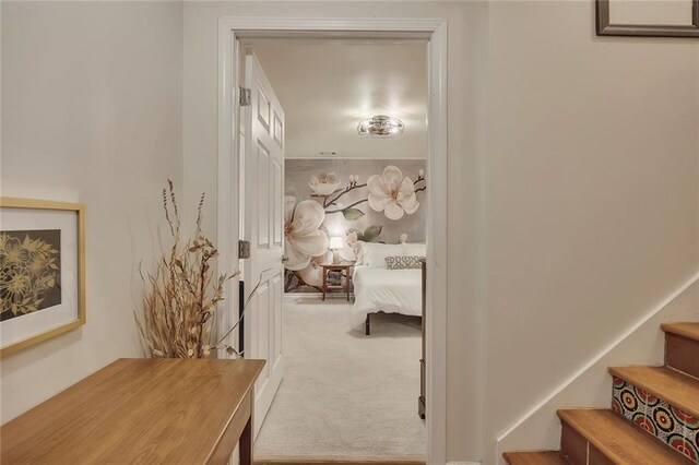 hall with carpet flooring and stairs