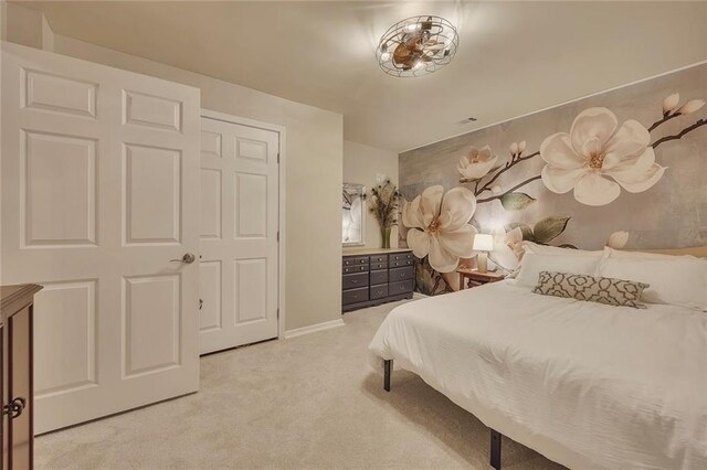 bedroom with light carpet and baseboards