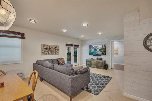 living room featuring baseboards, light tile patterned floors, french doors, and recessed lighting