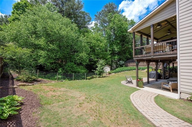 view of yard featuring a patio, ceiling fan, and a deck