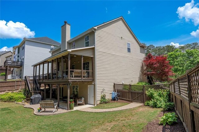 back of house featuring a patio, stairs, a deck, a chimney, and ceiling fan