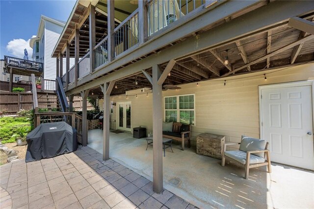 view of patio featuring stairs, area for grilling, and fence