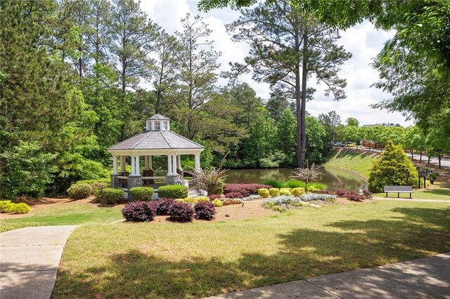 view of grassy yard with a gazebo and a water view
