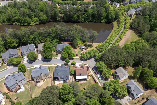 aerial view of property's location featuring a large body of water and nearby suburban area