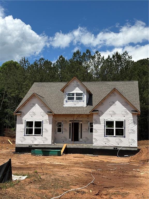 rear view of property with a shingled roof