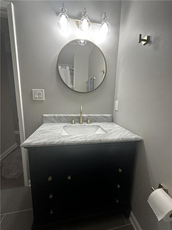 bathroom featuring tile patterned flooring, vanity, and baseboards