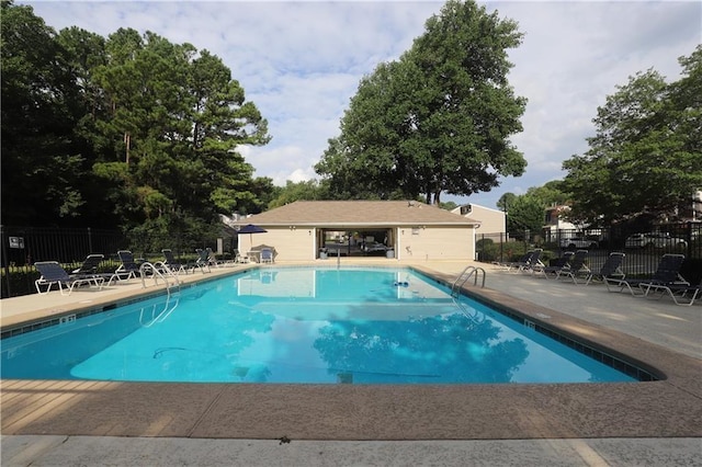 community pool featuring a patio area and fence