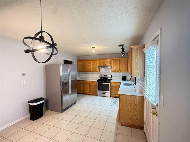2658 Deann Dr, Ellenwood, GA 30294 - kitchen featuring appliances with stainless steel finishes, light countertops, backsplash, a textured ceiling, and light tile patterned floors