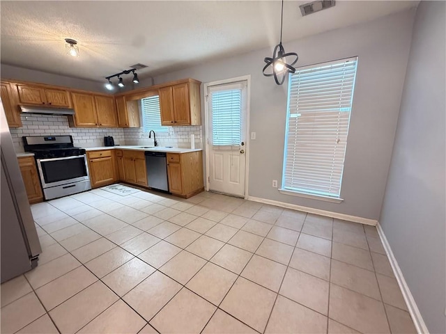 2658 Deann Dr, Ellenwood, GA 30294 - kitchen featuring stainless steel appliances, light countertops, tasteful backsplash, under cabinet range hood, and light tile patterned floors