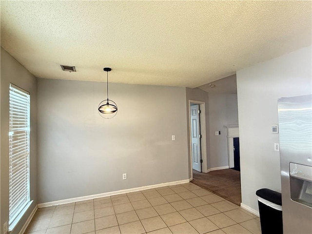 2658 Deann Dr, Ellenwood, GA 30294 - unfurnished dining area featuring a textured ceiling and light tile patterned floors