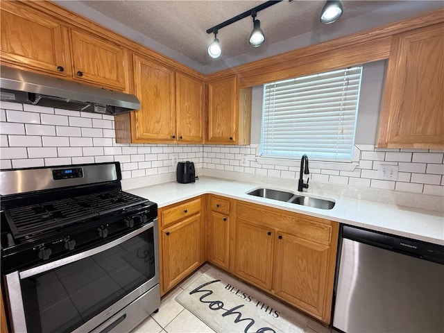 2658 Deann Dr, Ellenwood, GA 30294 - kitchen featuring stainless steel appliances, under cabinet range hood, light countertops, tasteful backsplash, and light tile patterned floors