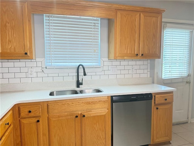 2658 Deann Dr, Ellenwood, GA 30294 - kitchen featuring stainless steel dishwasher, light countertops, tasteful backsplash, and light tile patterned floors