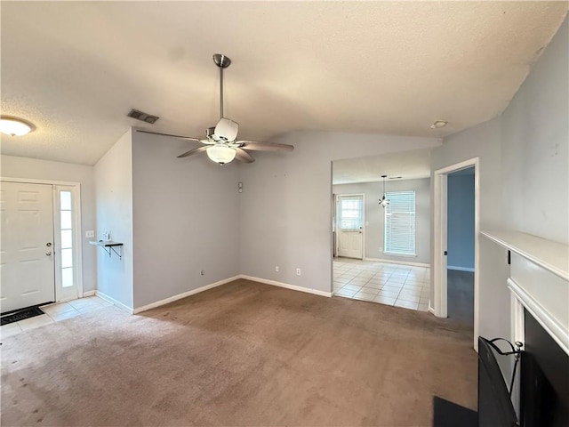2658 Deann Dr, Ellenwood, GA 30294 - unfurnished living room featuring carpet floors, lofted ceiling, a textured ceiling, a ceiling fan, and tile patterned floors