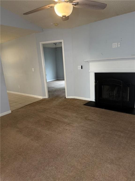 2658 Deann Dr, Ellenwood, GA 30294 - unfurnished living room featuring carpet floors, a ceiling fan, and a fireplace with flush hearth