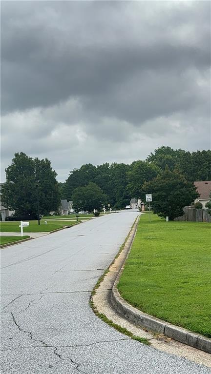 2658 Deann Dr, Ellenwood, GA 30294 - view of asphalt road with curbs and traffic signs