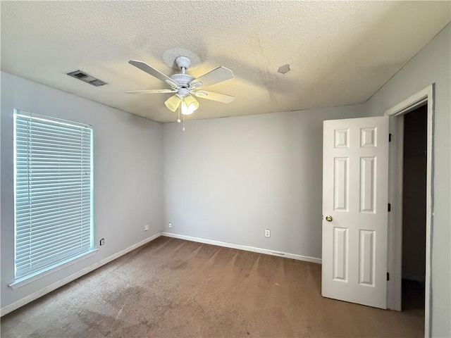 2658 Deann Dr, Ellenwood, GA 30294 - unfurnished bedroom featuring carpet, a textured ceiling, and a ceiling fan