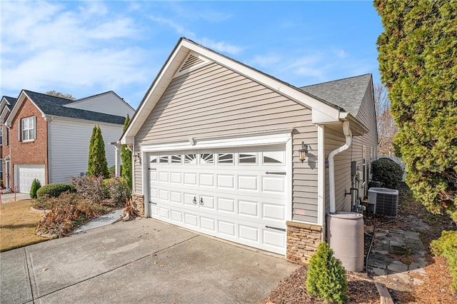 view of home's exterior with a garage and central air condition unit