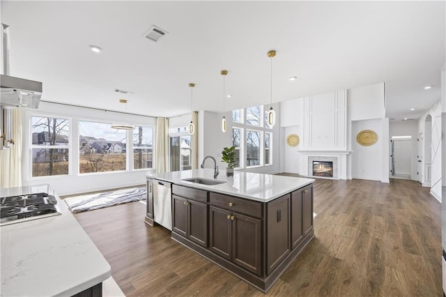 kitchen with pendant lighting, sink, a healthy amount of sunlight, and appliances with stainless steel finishes