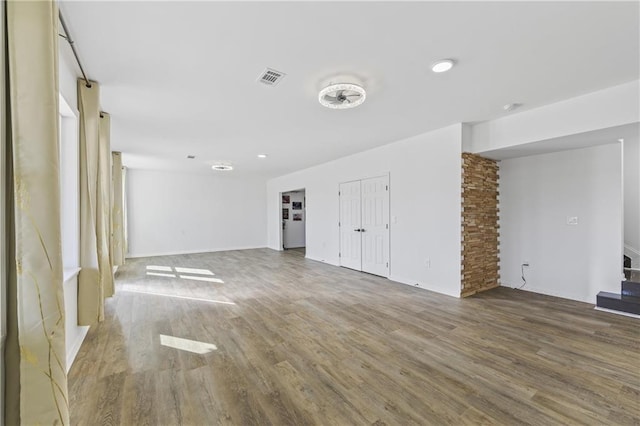 unfurnished living room featuring wood-type flooring