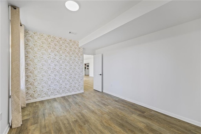 spare room featuring wood-type flooring