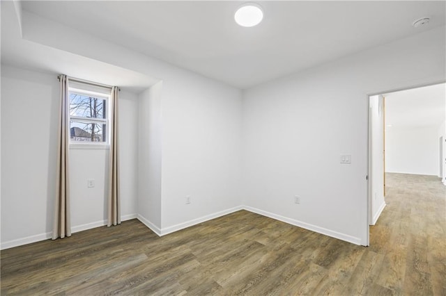 unfurnished room featuring dark hardwood / wood-style flooring