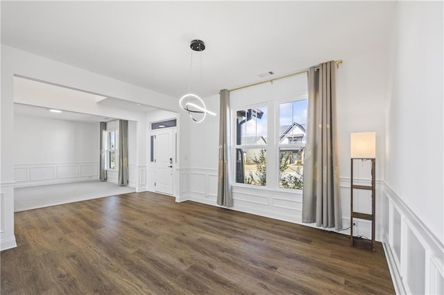 unfurnished dining area with dark hardwood / wood-style floors