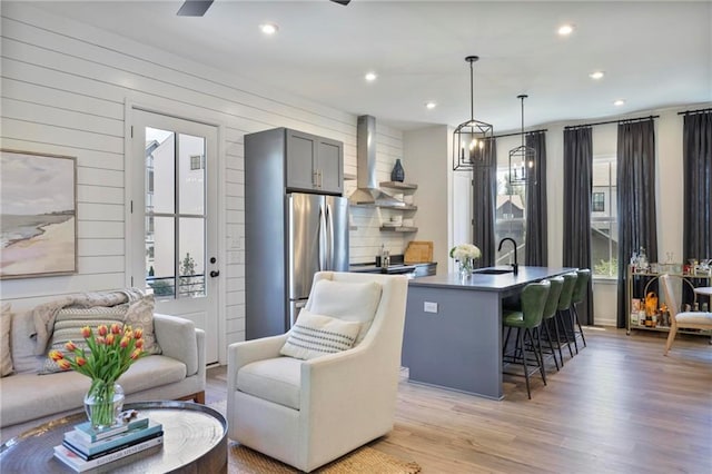 126 Chestnut Cir, Atlanta, GA 30342 - kitchen with wall chimney exhaust hood, freestanding refrigerator, a sink, open floor plan, and recessed lighting