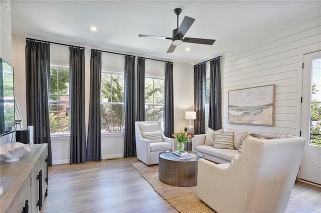 126 Chestnut Cir, Atlanta, GA 30342 - living room featuring light wood-style floors, a ceiling fan, recessed lighting, baseboards, and wooden walls