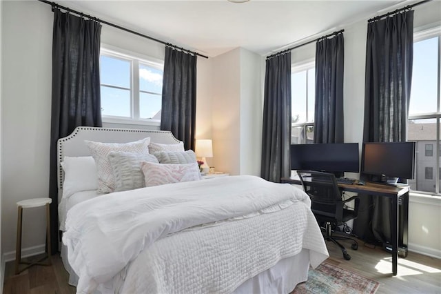 126 Chestnut Cir, Atlanta, GA 30342 - bedroom featuring wood finished floors, a desk, and baseboards