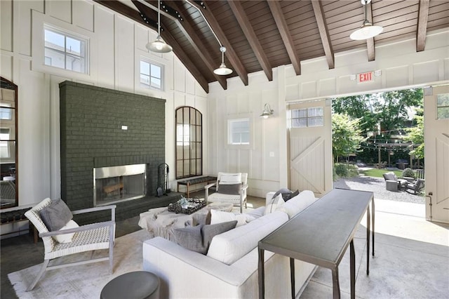 126 Chestnut Cir, Atlanta, GA 30342 - living room featuring high vaulted ceiling, a fireplace, wood ceiling with exposed beams, and concrete flooring