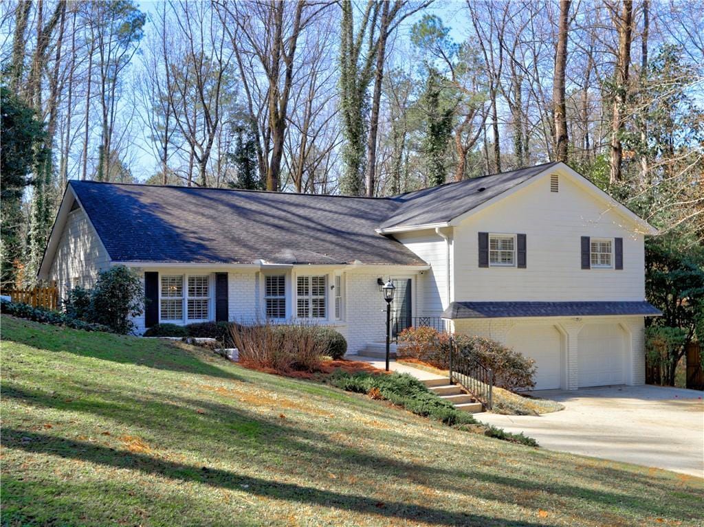 view of front of house with a garage and a front yard