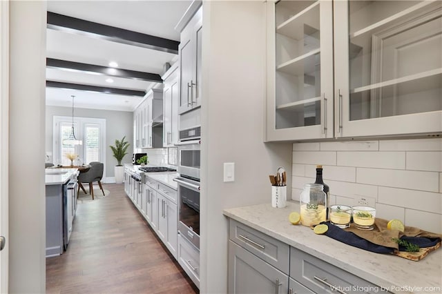 4884 Kentwood Dr, Marietta, GA 30068 - kitchen with decorative backsplash, pendant lighting, light stone counters, glass insert cabinets, and dark wood-type flooring