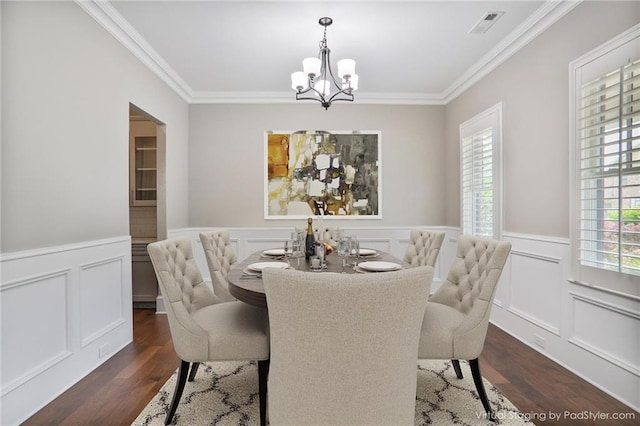 4884 Kentwood Dr, Marietta, GA 30068 - dining space featuring an inviting chandelier, ornamental molding, dark wood finished floors, and visible vents