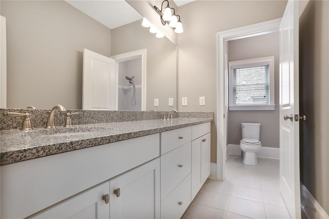 4884 Kentwood Dr, Marietta, GA 30068 - bathroom featuring double vanity, toilet, baseboards, tile patterned floors, and a sink