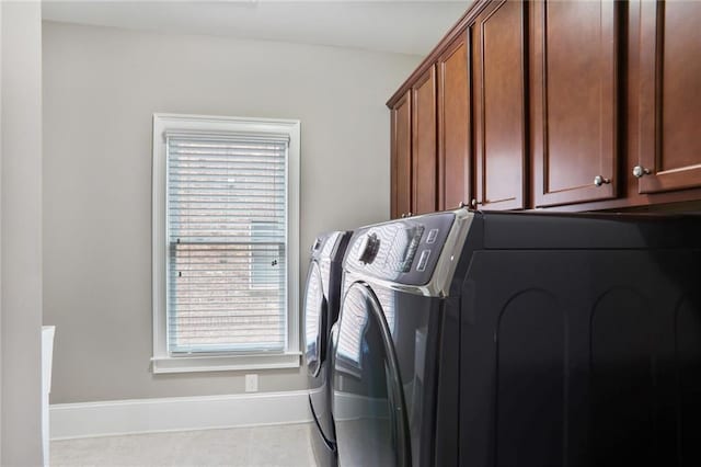 4884 Kentwood Dr, Marietta, GA 30068 - laundry room with washing machine and clothes dryer, baseboards, tile patterned flooring, and cabinet space